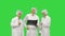 Three doctors rhythmically look at an x-ray photo of a patient together on a Green Screen, Chroma Key.