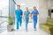 Three doctors running throtugh the hospital corridor being in a hurry