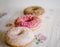 Three donuts on a background in the style of a shabby chic.