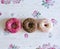 Three donuts on a background in the style of a shabby chic.