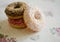 Three donuts on a background in the style of a shabby chic.