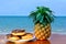 Three donuts placed on a plate and pineapple placed on a wooden