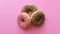 Three donuts ring rotating isolated on pink background. Shot on RED Raven 4k Cinema Camera