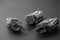 Three dried persimmons on a dark background