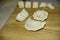 Three dumplings of different shape on the wooden deck