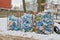 Three dumpsters full of plastic bottles, bags and waste