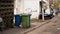 Three dumpsters, outdoor with sunlight background