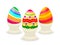 Three easter eggs on cups isolated