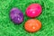 Three easter eggs in the grass