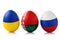 Three Easter eggs painted in colors of the flags of Ukraine, Belarus and Russia