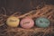 Three easter eggs on straw bed with words