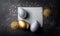 three easter eggs on a white card surrounded by gold and silver confetti. generative ai