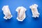 Three eclairs on a blue flat background, flat lay, closeup