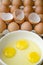 Three eggs in a bowl with their yellow yolks