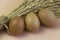 Three Eggs with brown shell put in front of blurred dried flower