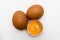 Three eggs, one broken egg, top view, egg yolk, isolated on white background