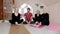 Three elderly women practice yoga exercises with an instructor at home.