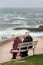 Three elderly women sitting on the bench and talking in front of