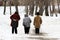 Three elderly women walking along the Avenue in winter
