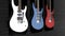 Three electric guitars hanging on a wall. Animation of three guitars hanging on the wall