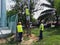 Three electricians are installing three phase overhead four core power cable on concrete spun