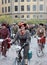 Three elegant cycling woman wearing old fashioned tweed clothes