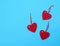 Three empty felt red hearts on a blue background