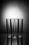 Three empty glasses on a blackand white background with reflecti