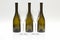 Three empty upturned wine bottles and two glasses on a white background