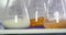 Three erlenmeyer flasks with some food samples in them being rotated - food quality check