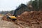 Three excavators in the process of work digs