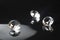 Three excellent pure diamonds with reflection on black mirror background close up view selective focus. Jewelry diamonds sale,