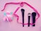 three eyeshadow brushes, to create makeup on a pink background, next to a satin ribbon. Beauty industry. Woman flat lay makup