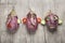 Three faces made with eggplant on wooden board