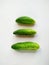 Three farm cucumbers isolated on white background