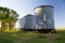 Three farm grain silos for agriculture. New and old silos.