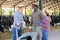 Three farmers in a cowshed discuss current issues