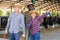 Three farmers in a cowshed discuss current issues