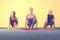 Three female adults practicing yoga in class