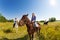 Three female equestrians riding horses in field