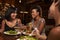 Three female friends enjoying dinner at a restaurant