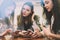 Three female friends enjoying meeting in cozy cafe