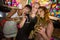 Three female friends having glass of champagne and wine