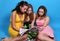 Three female friends reading glossy magazine
