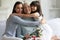 Three female generations celebrating International Womens Day looking at camera