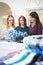 Three Female Voluntary Workers In Charity Shop