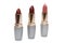 Three feminine lipsticks