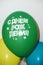 Three festive balloons, on the green it is written in Russian happy birthday.