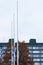 Three finnish flags lowered to half mast on the occasion of mourning at cloudy autumn day