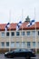 Three finnish flags lowered to half mast on the occasion of mourning at cloudy autumn day